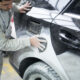 car painter preparing car painting workshop 80x80